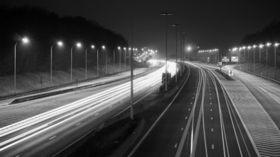 Light Trails On Road In Illuminated City At Night