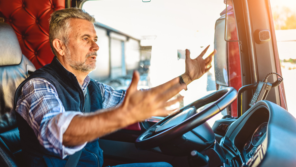 Truck driver yelling at someone while driving.