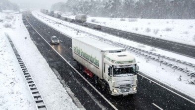 Traffic on a highway during a snow blizzard in winter